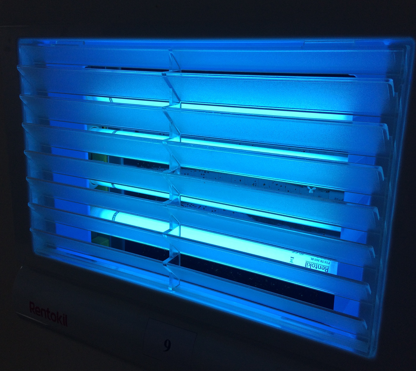 Blue-lit insect trap with horizontal slats.