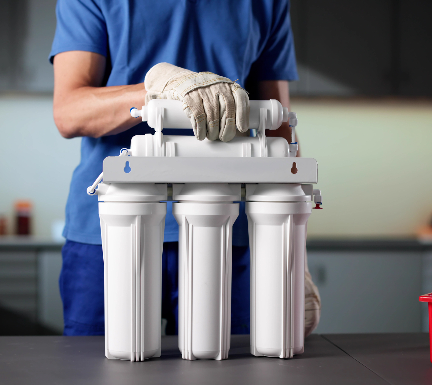 Person installing a water filtration system.